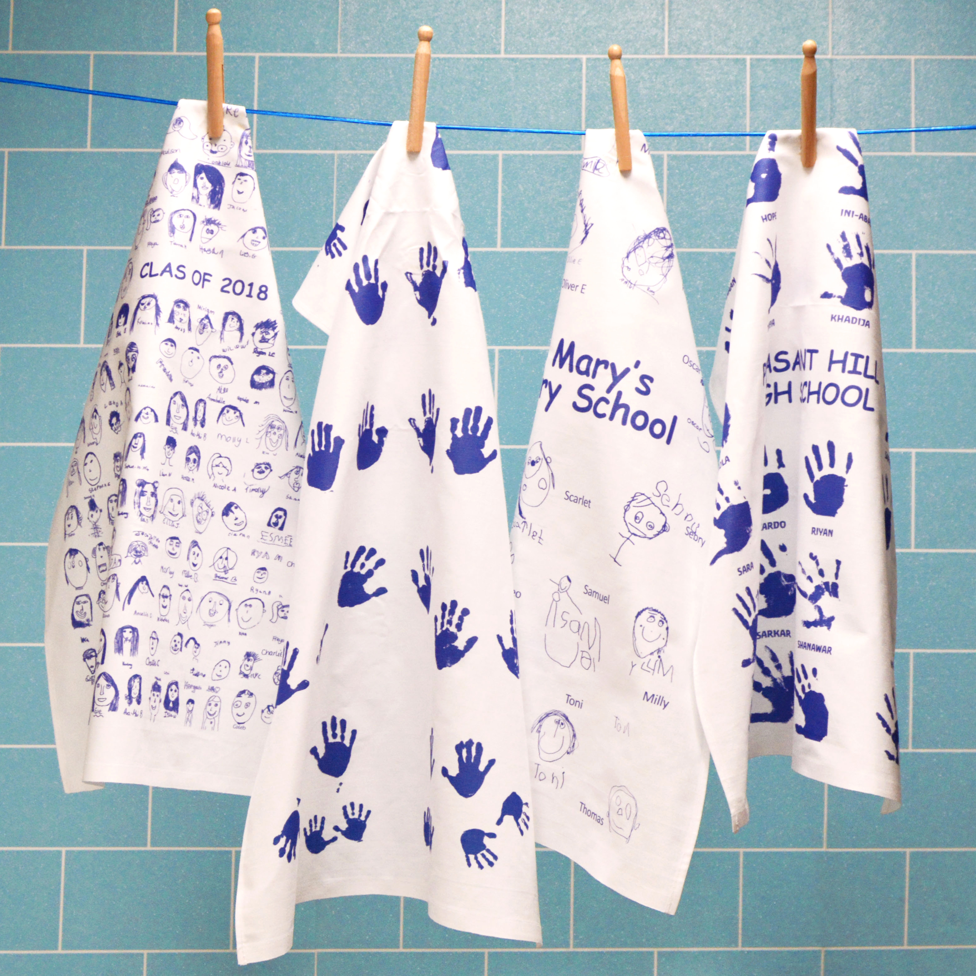image of 4 printed white cotton tea towels with self portraits designed by the pupils of the represented schools