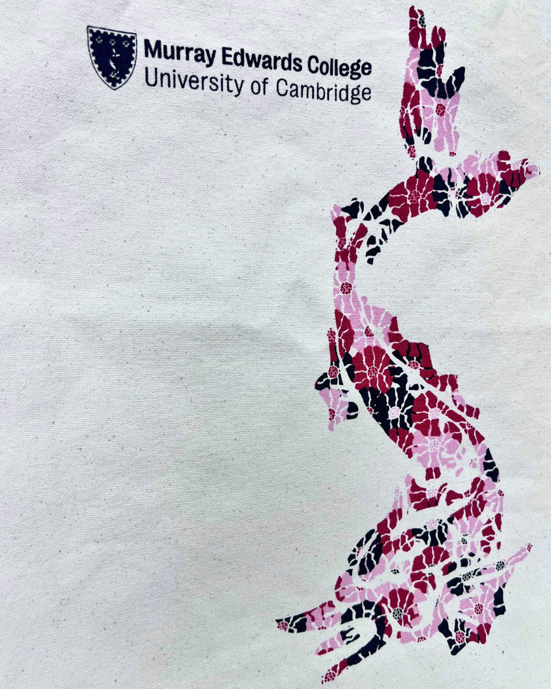 close up of the image with a red/pink/black dragon created from flowers printed on the bag