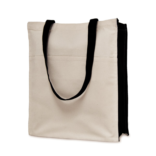 Beige tote bag with black sides and handles. The bag has a full width front pocket about two-thirds the height of the bag.