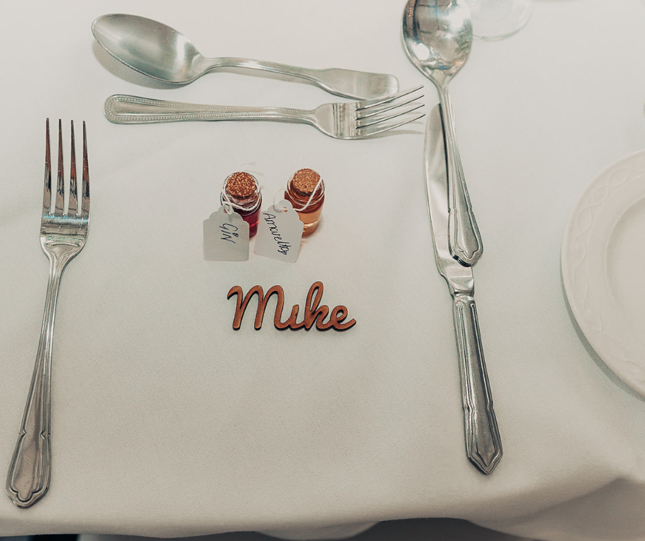 A picture containing fork, kitchen utensil, silverware, plate, wooden place name