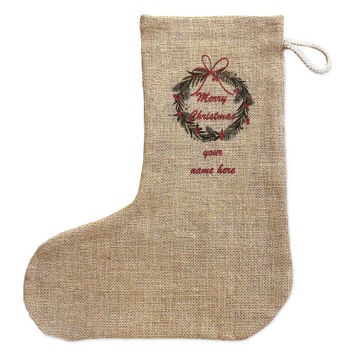 Rustic natural brown jute Christmas stocking with braided cotton hanging loop. Printed on one side is a traditional green and red Christmas wreath design with Merry Chrustmas and a space for 