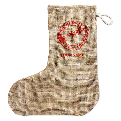 Rustic natural brown jute Christmas stocking with braided cotton hanging loop. Printed on one side is a design in the style of a stamp saying North Pole Express Delivery and a sleigh pulled b