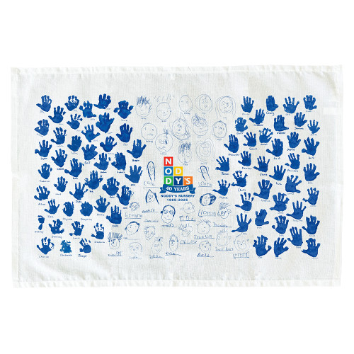 White tea towel printed with children's hand prints and drawings, with a colourful logo in the centre for the nursery which is celebrating its 40th year or providing childcare.
